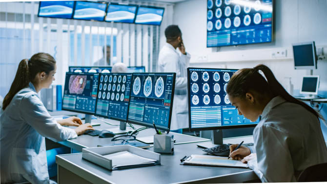 Medical professionals in white coats observing brain scans